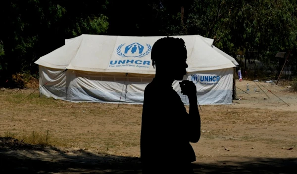 A refugee stands in front of a tent at a camp inside the UN-controlled buffer zone that divides the north part of the Turkish-occupied area from the south Greek Cypriots, Cyprus, Aug 9, 2024. (AP)