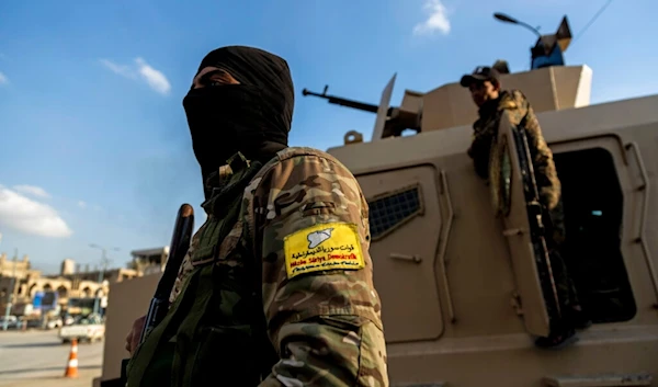 US-backed Syrian Democratic Forces (SDF) fighters stand guard at Al Naeem Square, in Raqqa, Syria, Monday, Feb. 7, 2022. (AP)