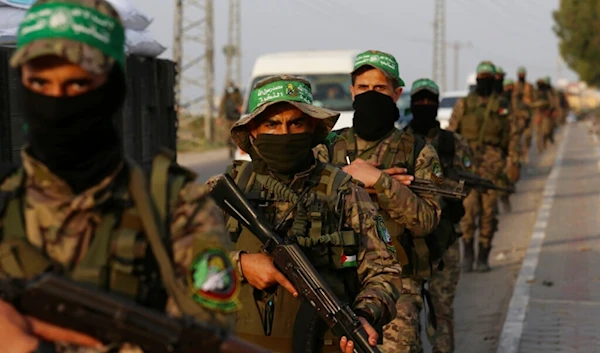 Members of al-Qassam Brigades, a military wing of Hamas, march with their rifles along the main road of Nusseirat refugee camp, central Gaza Strip, Palestine, Oct. 28, 2021. (AP)