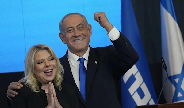 Benjamin Netanyahu and his wife Sara gesture after the first exit poll results for the Israeli Parliamentary election at his party’s headquarters in al-Quds, on November, 2022. (AP)