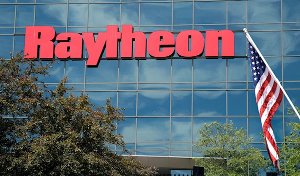 An American flag flies in front of the facade of Raytheon's Integrated Defense Systems facility, in Woburn, Mass on June 10, 2019. (AP)