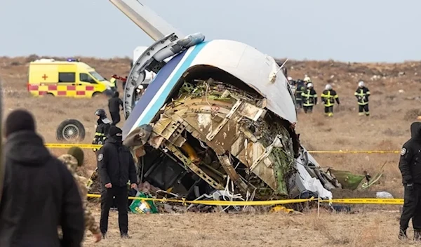 Emergency specialists work at the crash site of an Azerbaijan Airlines passenger jet near the western Kazakh city of Aktau on December 25, 2024. (AFP)