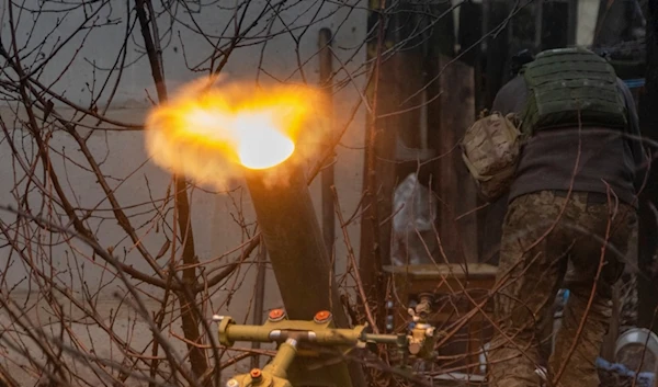 A Ukrainian serviceman of the 57th Mechanised Brigade fire 120mm mortar towards Russian positions near Kharkiv, Ukraine, Tuesday, December 24, 2024 (AP)