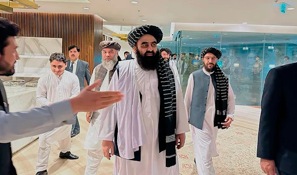 In this photo provided by Afghanistan Embassy in Pakistan, the Taliban-appointed Foreign Minister Amir Khan Muttaqi, center, walks with other officials upon his arrival in airport, in Islamabad, Pakistan, Friday, May 5, 2023. (AP)