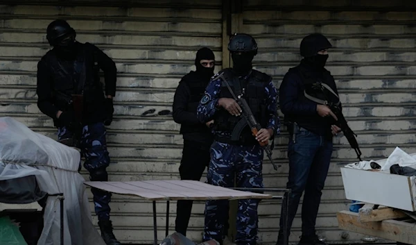 Officers from the PA clutch their guns as Palestinian security forces mount a major raid against militants in the Jenin refugee camp in the Israeli-occupied West Bank, Dec. 16, 2024. (AP)