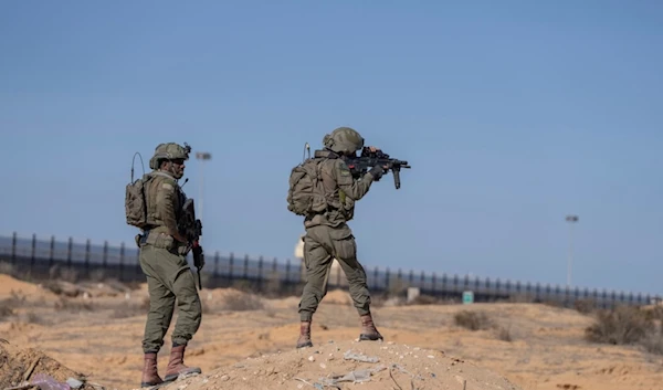 Israeli soldiers stand guard on the Gaza side of the Kerem Shalom crossing as reporters tour the area in the Gaza Strip, Thursday, Dec. 19, 2024. (AP)