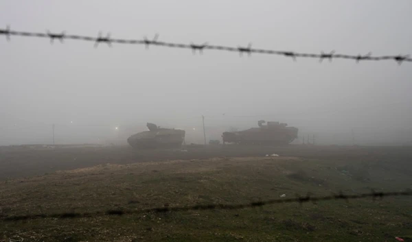 Israeli armored vehicles park on the side of a road in the Israeli-controlled Golan Heights, on Sunday, December 22, 2024 (AP)