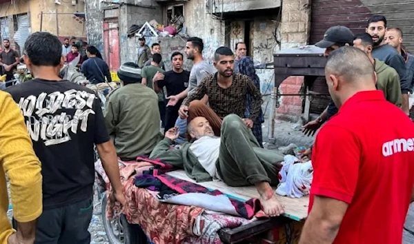 A man who was injured during Israeli bombardment on Beit Lahia, in the northern Gaza Strip, is placed on a cart on 4 Nov 2024 [AFP]