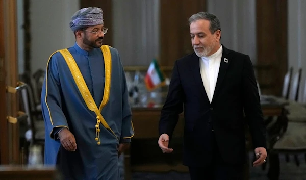 Iranian Foreign Minister Abbas Araghchi, right, speaks with his Omani counterpart Sayyid Badr Albusaidi as they arrive for a press briefing after their meeting in Tehran, Iran, Monday, Dec. 30, 2024 (AP)