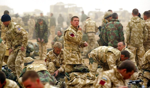 In this March 29, 2003 file photo, a soldier of the British 1st Batallion Parachute Regiment shaves in the early morning mist before operations in a camp in southern Iraq. (AP)