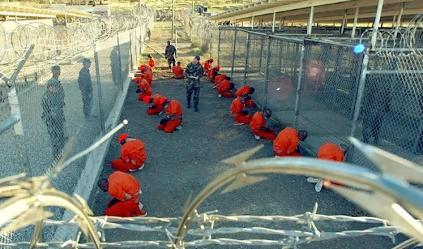 An image taken by the U.S. military on Jan. 11, 2002, showing the first prisoners at Guantánamo Bay, Cuba, soon after their arrival.(Petty Officer First Class Shane T. McCoy/U.S. Navy)