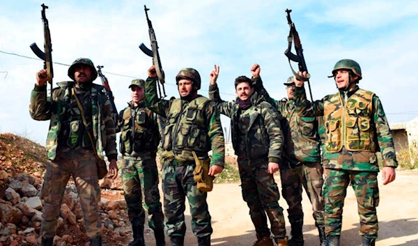 This Jan. 27, 2020, photo, show Syrian Arab Army soldiers chant slogans of victory as they hold their rifles, in western Aleppo, Syria, after its liberation. (SANA)