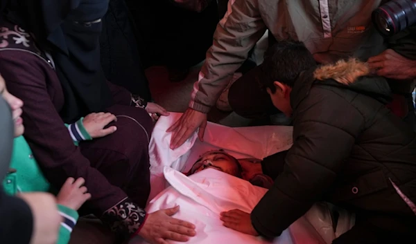 Palestinians mourn over the body of victim of an overnight Israeli strike, during a funeral in Deir al-Balah, Gaza Strip, Wednesday, Dec. 4, 2024. (AP)