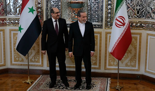 Syrian Foreign Minister Bassam Sabbagh, left, is welcomed by his Iranian counterpart Abbas Araghchi as they wait for the Syrian delegation prior to their meeting in Tehran, Iran, on November 19, 2024. (AP)