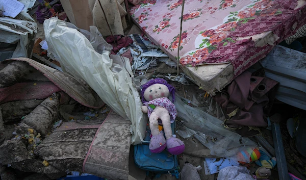 A doll lies among plastic debris and clothes in the aftermath of an Israeli airstrike at the Muwassi camp near Khan Younis, in the southern Gaza Strip, on Thursday, Dec. 5, 2024.(AP)