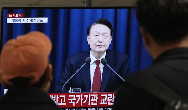 People watch a TV screen showing South Korean Presdienr Yoon Suk Yeol's televised briefing at a bus terminal in Seoul, South Korea on December 3,2024. (AP)