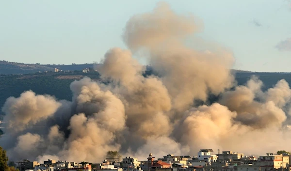 Smoke rises between buildings hit in Israeli airstrikes near the Palestinian refugee camp of Rashidiyeh, as seen from Tyre city, south Lebanon, Tuesday, Nov. 26, 2024. (AP)