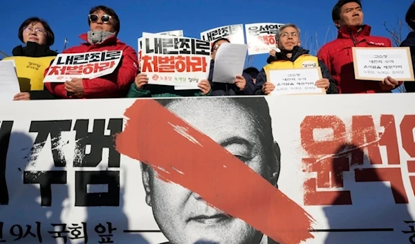 Protesters stage a rally to demand South Korean Presidenr Yoon Suk Yeol to step down in front of the National Assembly in Seoul, Wednesday Dec.4,2024. The signs read "Punish". (AP)