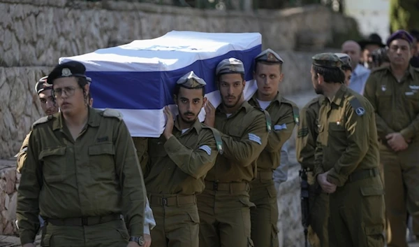 Israeli soldiers carry the coffin of combat engineer squad commander during his funeral at Mount Herzl military cemetery in al-Quds, occupied Palestine, Sunday, Nov. 1, 2024. (AP)