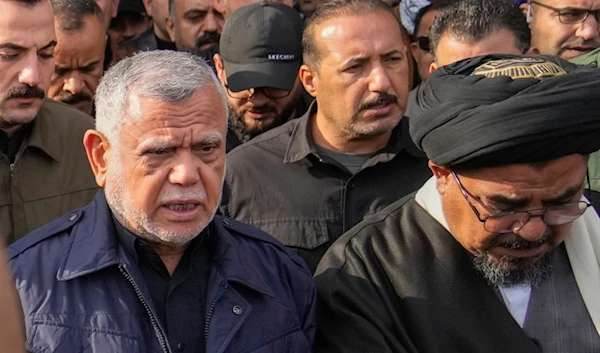 Leader of the Badr Organization, Hadi al-Amiri, left, attends a funeral for the group members who were killed by a US air strike, in Baghdad, Iraq, Sunday, February 4, 2024 (AP)