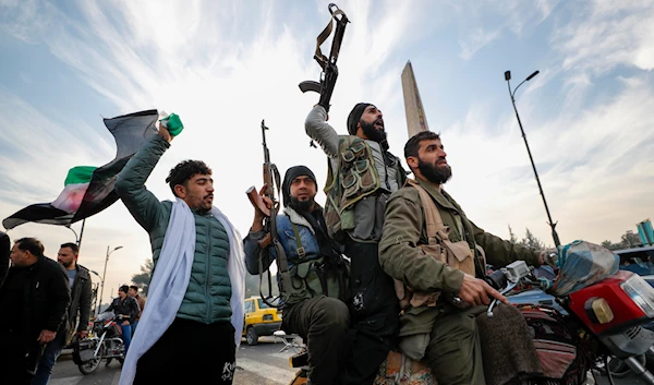 Syrian opposition fighters celebrate after the Syrian government collapsed in Damascus, Syria, on December 8, 2024. (AP)