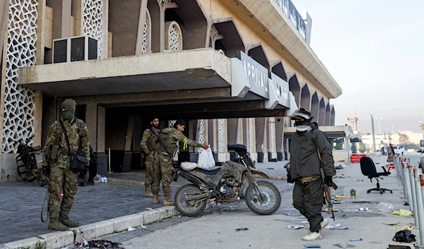 Syrian opposition fighters hang out at the arrivals gate of the Aleppo international airpot in Aleppo, Syria, on December 2, 2024. (AP)