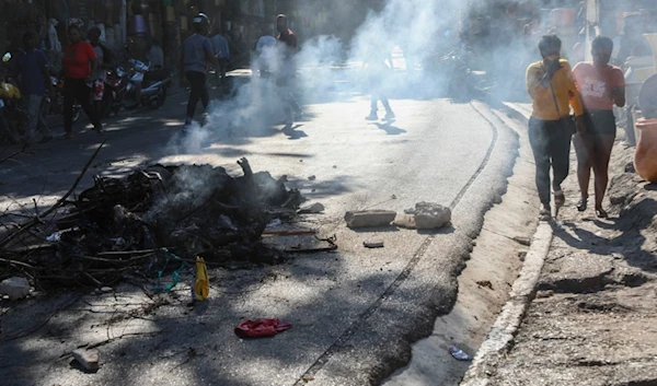 The bodies of suspected gang members who were set on fire by residents, sit in a pile in the middle of a road in the Pétion-Ville neighborhood of Port-au-Prince, Haiti, Tuesday, Nov. 19, 2024. (AP)