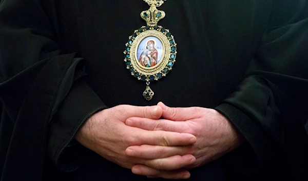 Greek Orthodox Patriarch of Antioch and all the East John X folds hands as he waits Russian Foreign Minister Sergey Lavrov for a meeting in Moscow, Russia, Tuesday, Dec. 5, 2017. (AP)