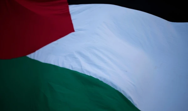 People flutter a Palestinian giant flag during a demonstration in support of the Palestinian people and demanding a cease fire in Gaza, in Lisbon, Friday, Dec. 8, 2023. (AP)