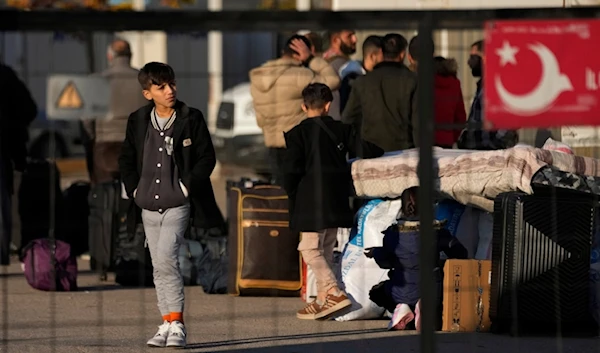 Syrians wait to cross into Syria from Turkey at the Oncupinar border gate, near the town of Kilis, southern Turkey, Monday, Dec. 9, 2024. (AP)