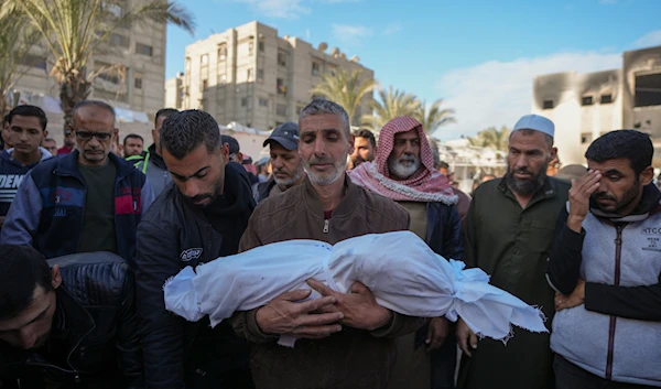 The body 18-month-old Sham Shurrab is carried by her uncle for burial in the aftermath of an Israeli airstrike at the Muwassi camp, outside the Nasser hospital in Khan Younis, southern Gaza Strip, on December 5, 2024. (AP)