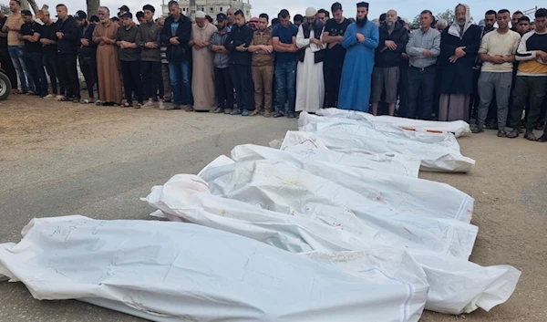 Mourners pray over the bodies of members of the Abu Taha family who were killed in an Israeli airstrike, during their funeral at Al-Salam cemetery, east of Rafah, Gaza Strip, April 29, 2024. (AP)