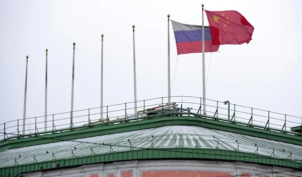 The flags of Russia and China flutter on the roof of a hotel with the flags of other countries removed, in central St. Petersburg, Russia, Wednesday, Nov. 30, 2022. (AP Photo/Dmitri Lovetsky)