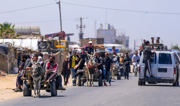 Displaced Palestinians arrive in central Gaza after fleeing from the southern Gaza city of Rafah in Deir al Balah, on May 9, 2024. (AP)