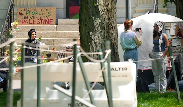 Students near the remnants of an encampment of tents in Harvard Yard, on the campus of Harvard University, Tuesday, May 14, 2024, in Cambridge, Mass. (AP)