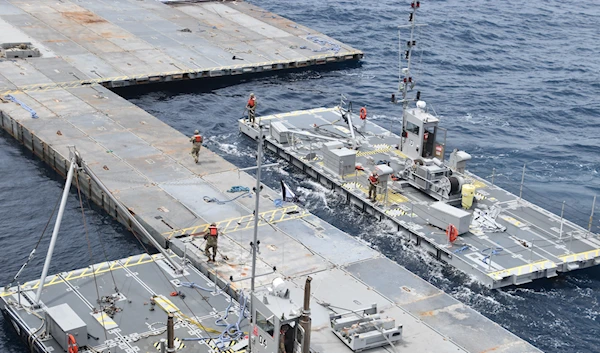 soldiers assigned to the 7th Transportation Brigade (Expeditionary) and sailors assemble the floating pier, off the shore of Gaza on April 26, 2024. (US Army/AP)