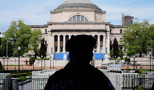 A New York City police officer looks over the center of Columbia University, in New York, May 6, 2024 (AP)