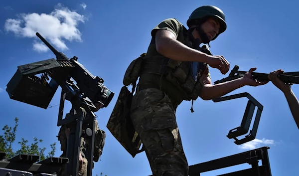 Ukrainian servicemen of mobile air defence unit of Ukraine's 141st separate infantry brigade prepare their machine gun for a duty in Zaporizhzhia region, Ukraine, on Thursday, May 16, 2024. (AP)