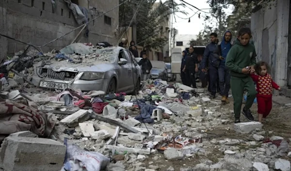 Palestinian children walk next to rubble from an Israeli airstrike in Rafah, Gaza Strip, on Friday, February 9, 2024. (AP)