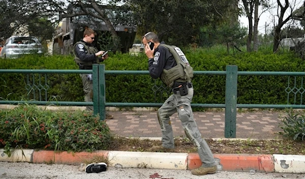 Israeli occupation forces examine the site hit by a rocked fired from Lebanon in Kiryat Shmona, northern occupied Palestine, Tuesday, Feb. 13, 2024. (AP)