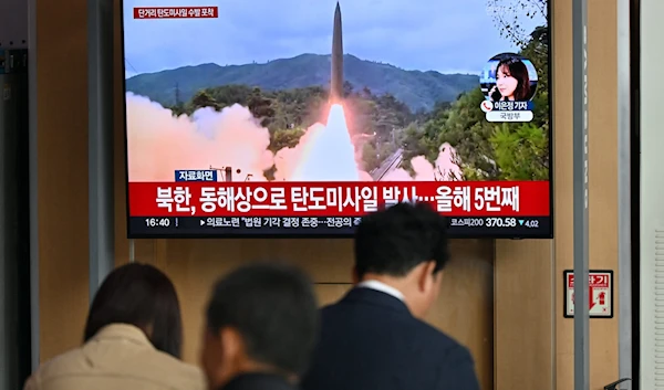 People watch a television screen showing a news broadcast with file footage of a North Korean missile test, at a railway station in Seoul on May 17, 2024. (AFP)