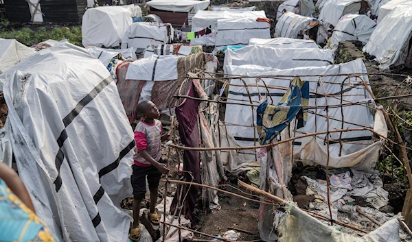 People gather at the side of an explosion in a refugee camp on the outskirts of Goma, Democratic Republic of the Congo, on May, 3, 2024. (AP)