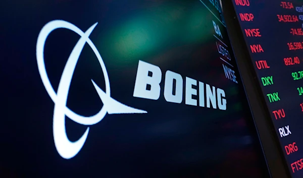 The logo for Boeing appears on a screen above a trading post on the floor of the New York Stock Exchange, July 13, 2021. (AP)