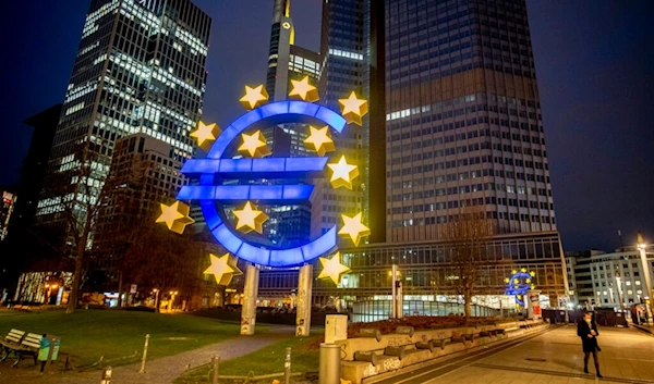 A man walks past the Euro sculpture in Frankfurt, Germany, March 11, 2021. (AP)