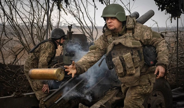 Ukrainian soldiers with the 71st Jaeger Brigade fire a M101 howitzer at Russian positions on the front line, near the city of Avdiivka in Ukraine's Donetsk region, on March 22, 2024 (AP)