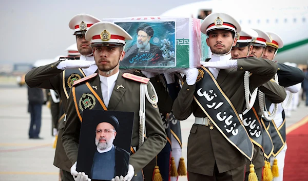 Army members carry the flag-draped coffin of President Ebrahim Raisi during a funeral ceremony at Mehrabad airport in Tehran, Iran, Tuesday, May 21, 2024. (Iranian Presidency Office/AP)