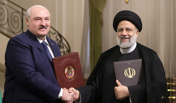 Iranian President Ebrahim Raisi with Belarusian President Alexander Lukashenko after a signing ceremony following their talks at the Saadabad Palace in Tehran, Iran, Monday, March 13, 2023. (AP)