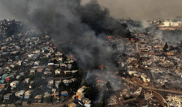 A wildfire reduces homes to rubble and ash on the hills of Viña del Mar, Chile, on February 3, 2024. (AFP)