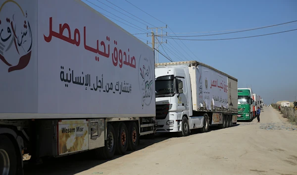 Trucks carrying humanitarian aid enter the Gaza Strip from Egypt in Rafah during a previous temporary ceasefire that went into effect Friday, Nov. 24, 2023. (AP)