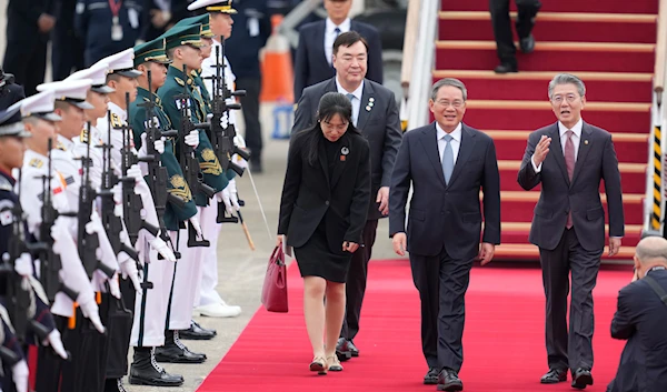 Chinese Premier Li Qiang, second right, is welcomed by South Korean 1st Vice Minister Kim Hong-kyun, as the premier arrives for a trilateral meeting, at the Seoul airport in Seongnam, South Korea, May 26, 2024 (AP)